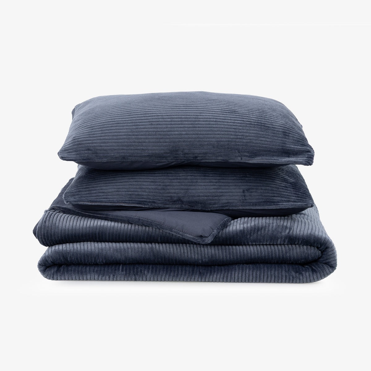 A folded navy blue corduroy comforter with a matching pillowcase stacked on top of a matching corduroy comforter, shown against a plain white background.