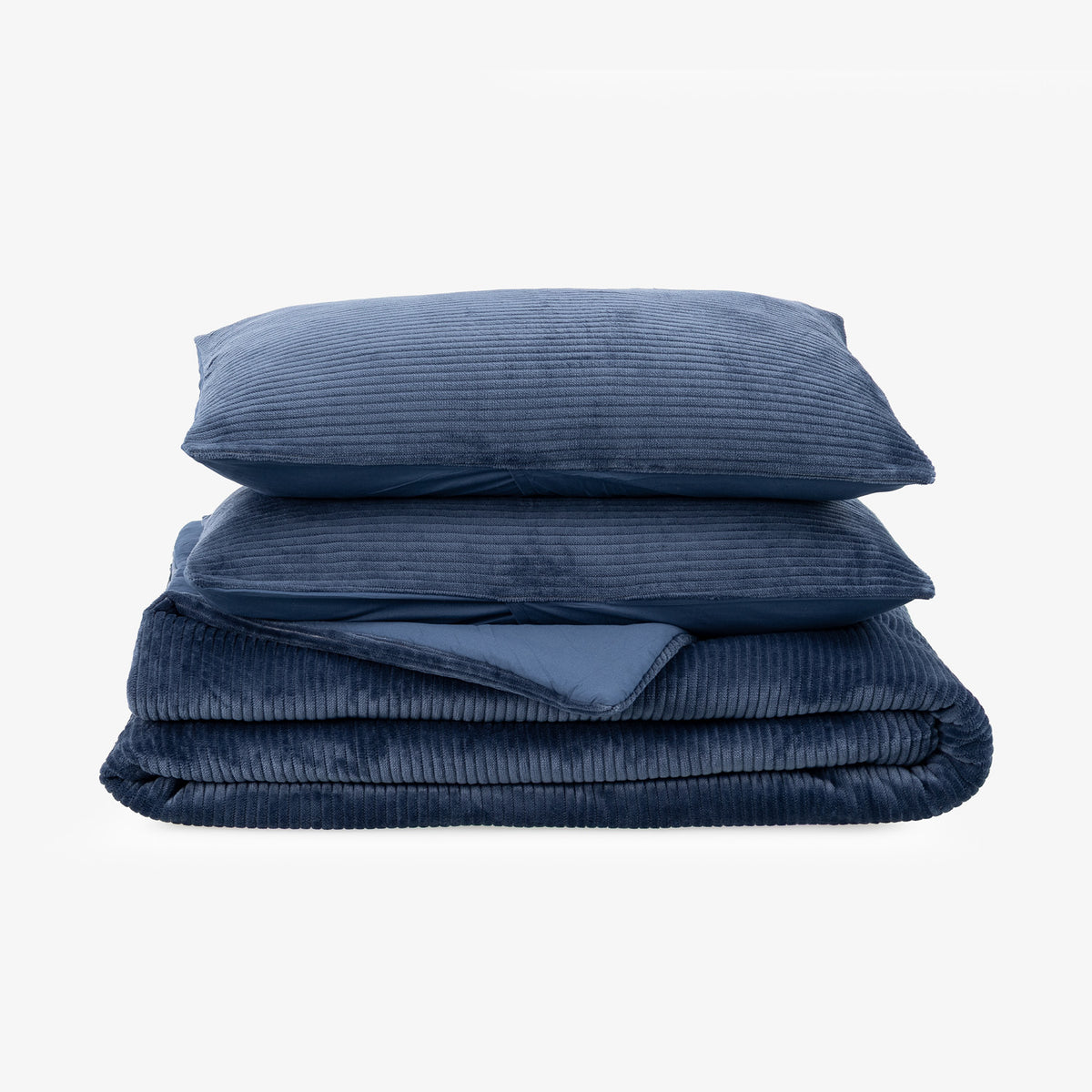 Navy blue corduroy comforter set folded neatly on a white surface.