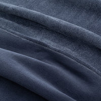 Close up of a blue chenille knit blanket.