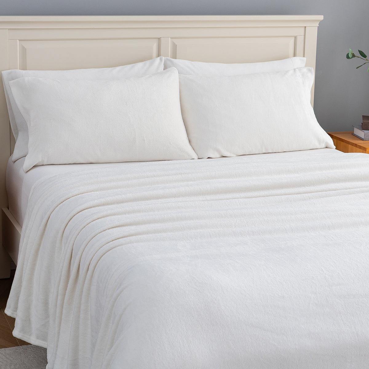 VelvetLoft® Plush Sheet Set in Cream on a made bed, angled view