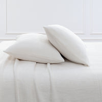 VelvetLoft® Plush Sheet Set pillowcases in Cream on a made bed against a white paneled wall