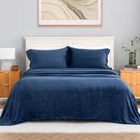 VelvetLoft® Plush Sheet Set in Dress Blues on a made bed with a cream headboard, front view