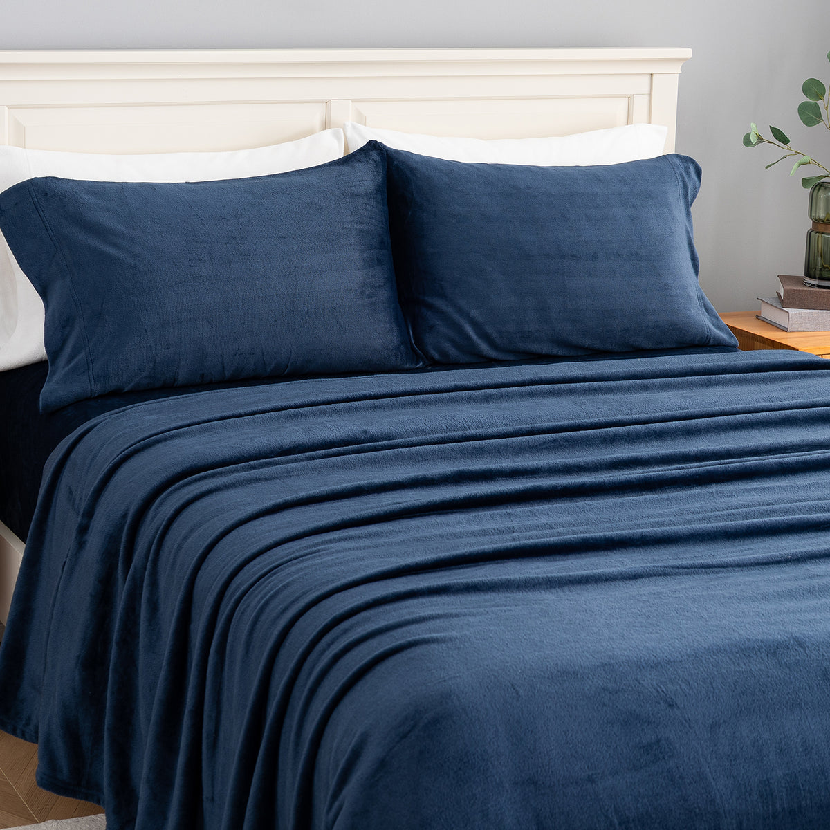 VelvetLoft® Plush Sheet Set in Dress Blues on a made bed, angled view