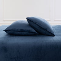 VelvetLoft® Plush Sheet Set pillowcases in Dress Blues on a made bed against a white paneled wall