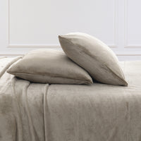 VelvetLoft® Plush Sheet Set pillowcases in Dry Sage on a made bed against a white paneled wall