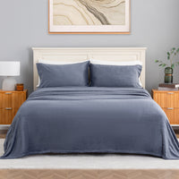 VelvetLoft® Plush Sheet Set in Galaxy Blue on a made bed with a cream headboard, front view