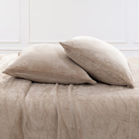 VelvetLoft® Plush Sheet Set pillowcases in Hummus on a made bed against a white paneled wall