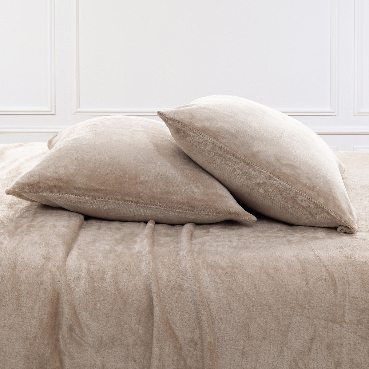 VelvetLoft® Plush Sheet Set pillowcases in Hummus on a made bed against a white paneled wall