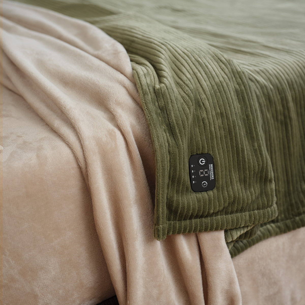 VelvetLoft® Plush Sheet Set in Hummus with a green ribbed blanket and its controller laid across it