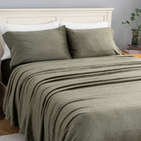 VelvetLoft® Plush Sheet Set in Ivy on a made bed, angled view
