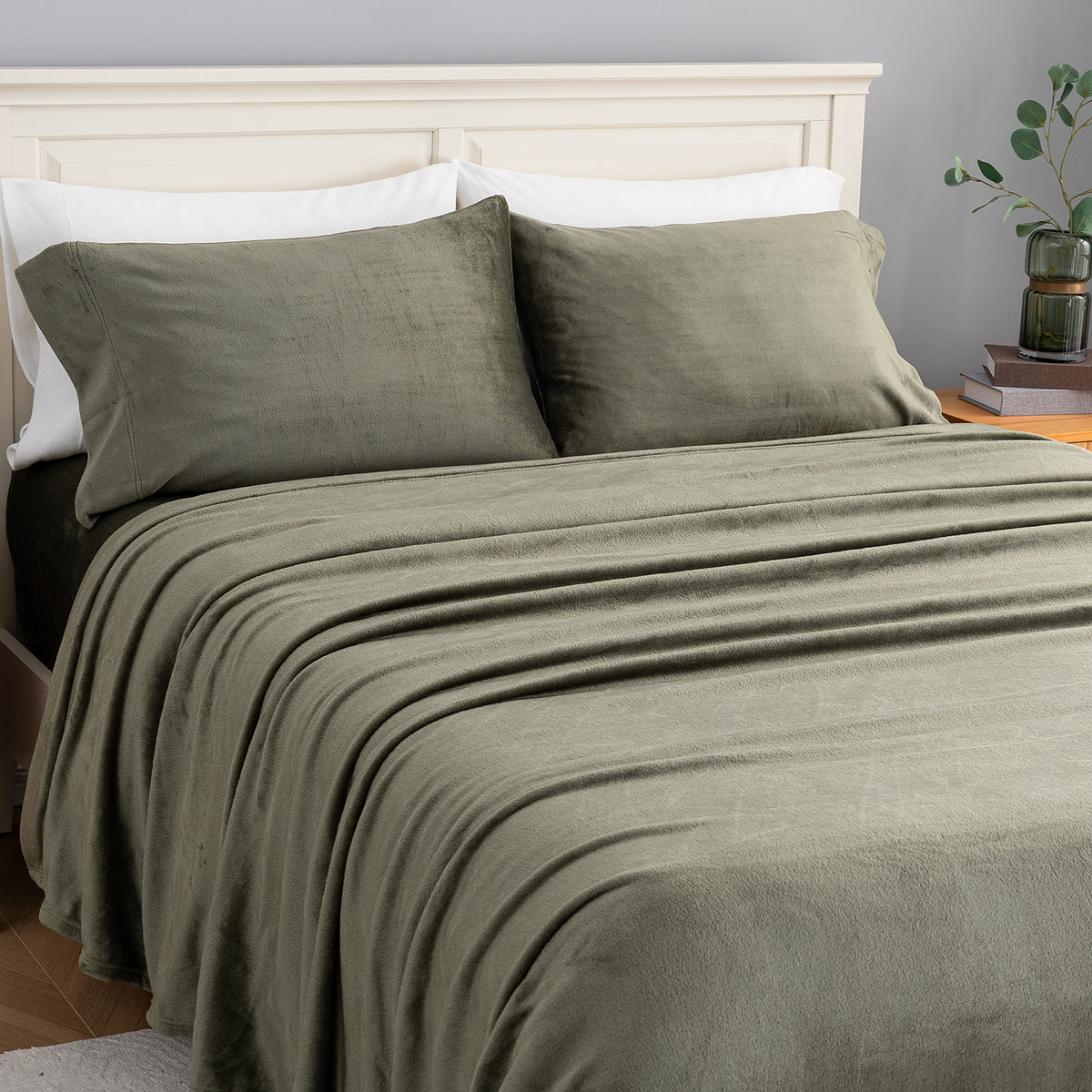 VelvetLoft® Plush Sheet Set in Ivy on a made bed, angled view