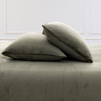 VelvetLoft® Plush Sheet Set pillowcases in Ivy on a made bed against a white paneled wall