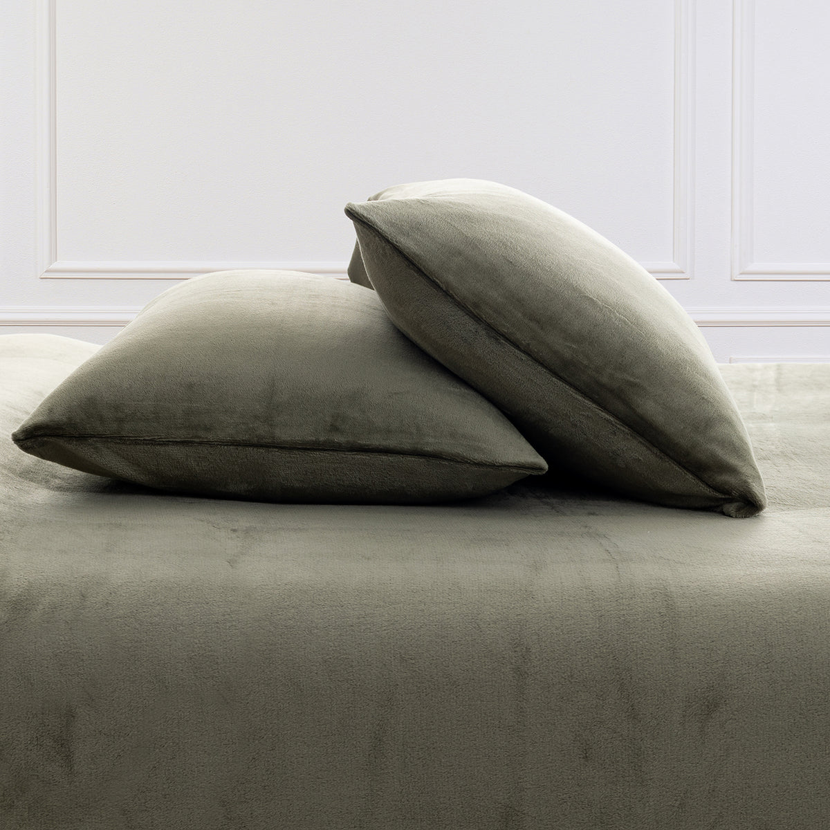 VelvetLoft® Plush Sheet Set pillowcases in Ivy on a made bed against a white paneled wall