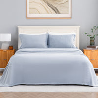 VelvetLoft® Plush Sheet Set in Polar Blue on a made bed with a cream headboard, front view