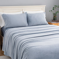 VelvetLoft® Plush Sheet Set in Polar Blue on a made bed, angled view