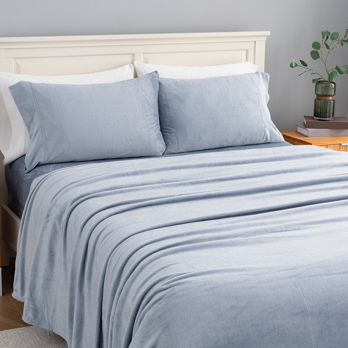 VelvetLoft® Plush Sheet Set in Polar Blue on a made bed, angled view