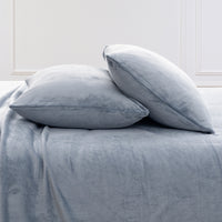 VelvetLoft® Plush Sheet Set pillowcases in Polar Blue on a made bed against a white paneled wall