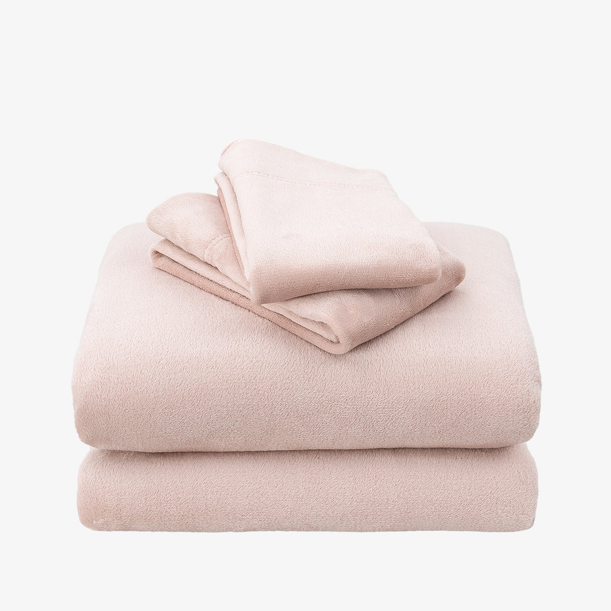 A stack of three folded plush bedding pieces, likely a blanket, pillowcase, and pillow sham, in a soft dusty pink color, set against a plain white background.