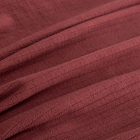 Close up of a Polartec Microfleece Blanket in deep fig.