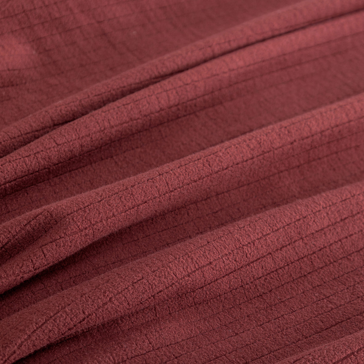 Close up of a Polartec Microfleece Blanket in deep fig.