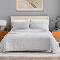 VelvetLoft® Plush Sheet Set in Textured Wisp Grey on a made bed with a cream headboard, front view