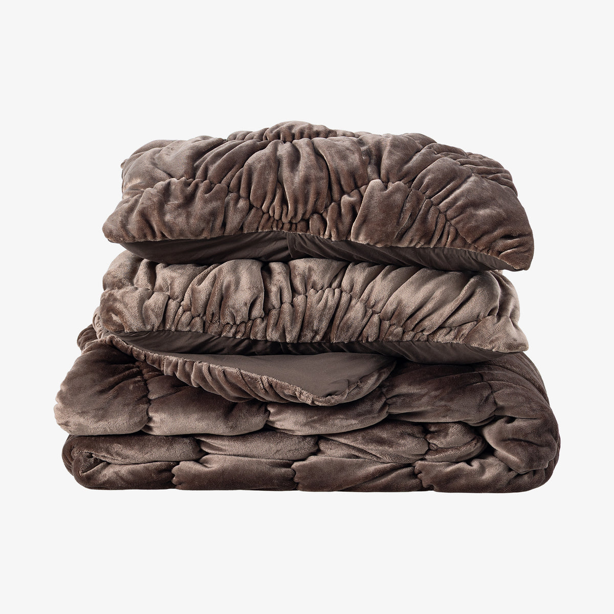 A brown ruched VelvetLoft Comforter Set folded neatly on a white surface.