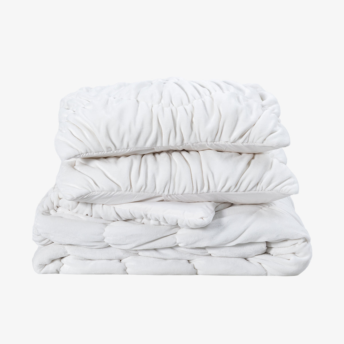 A white ruched VelvetLoft Comforter Set folded neatly on a white surface.