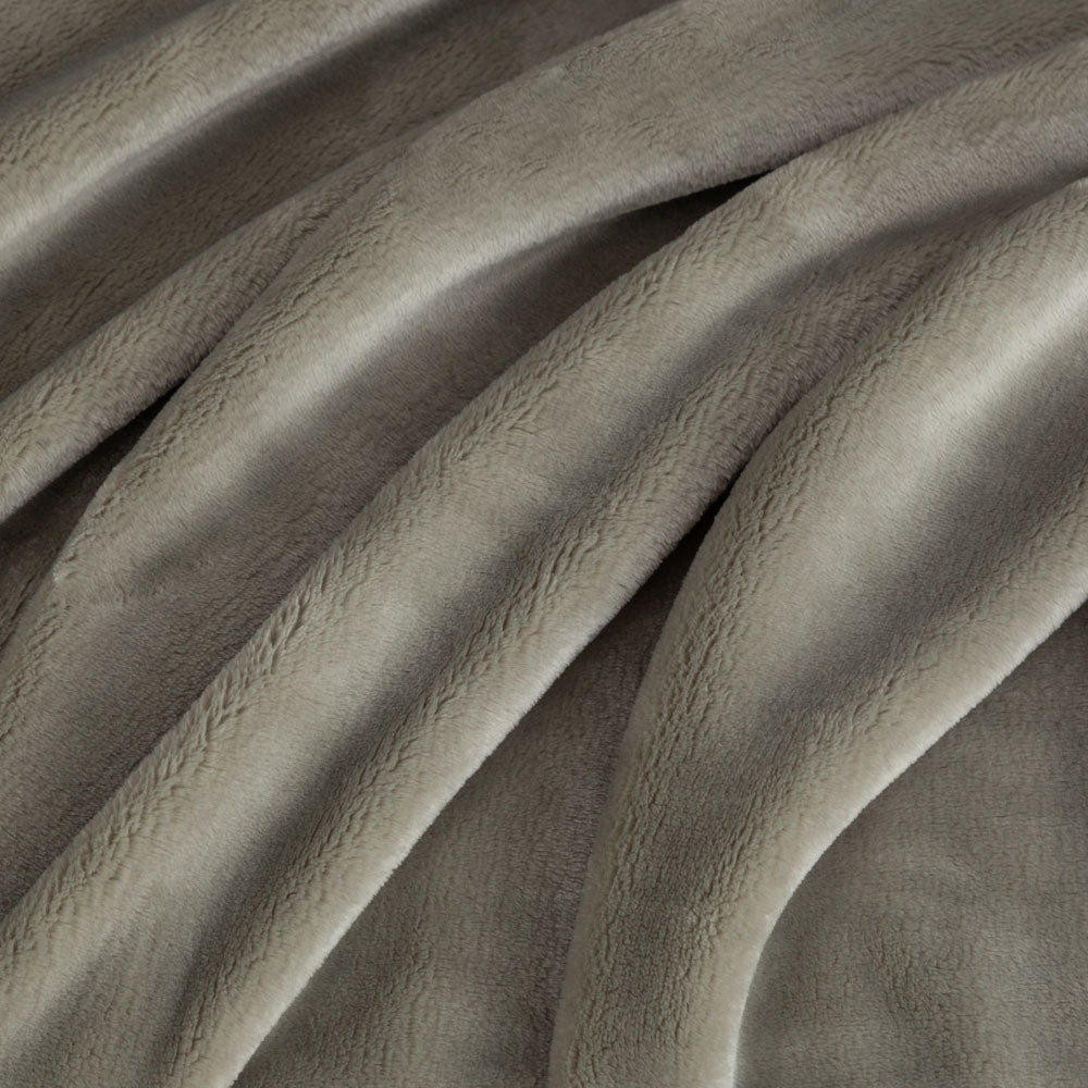 Close-up of textured green fabric with folds