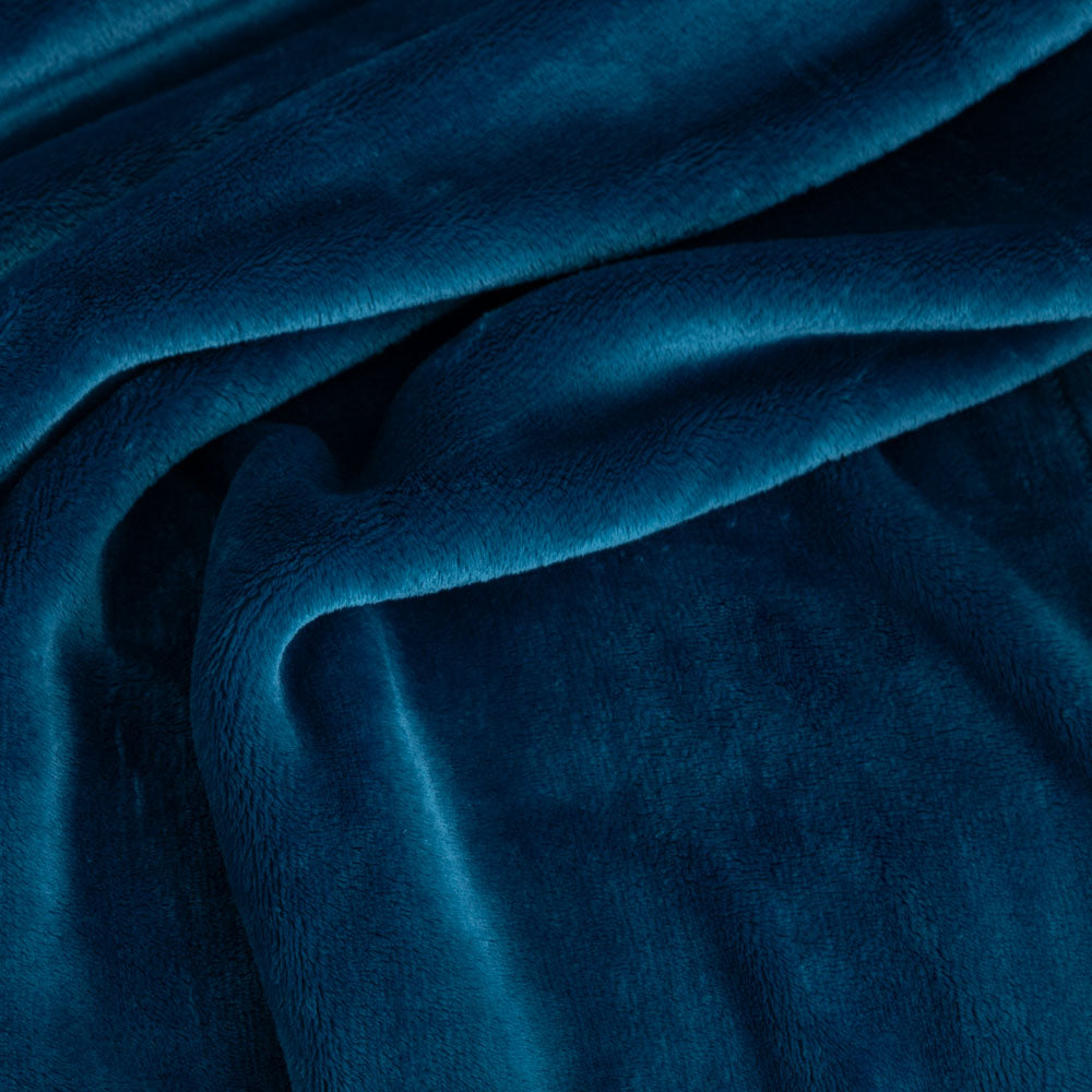 Close-up of blue velvet fabric with folds