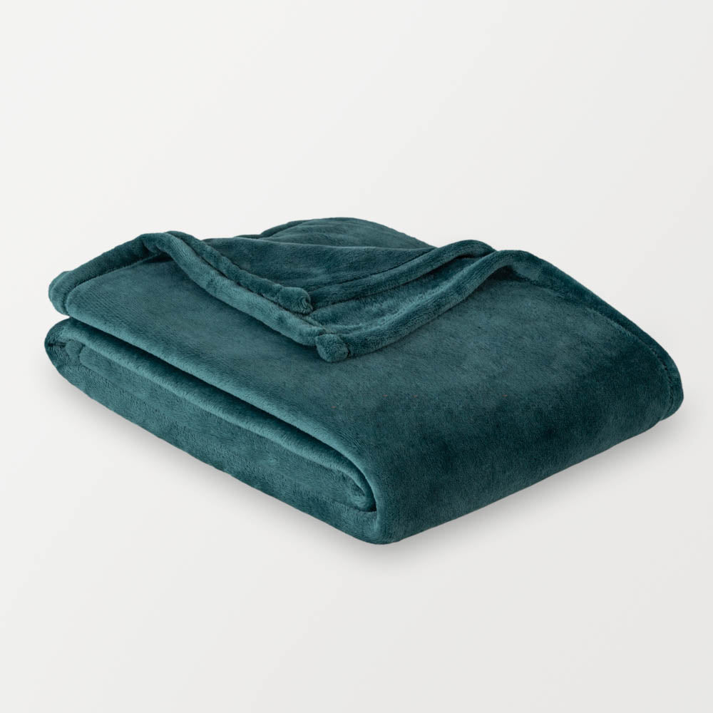 Teal blanket folded on a light gray background
