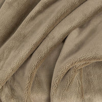 A close up of a green PrimaLush Throw displaying its plush texture.