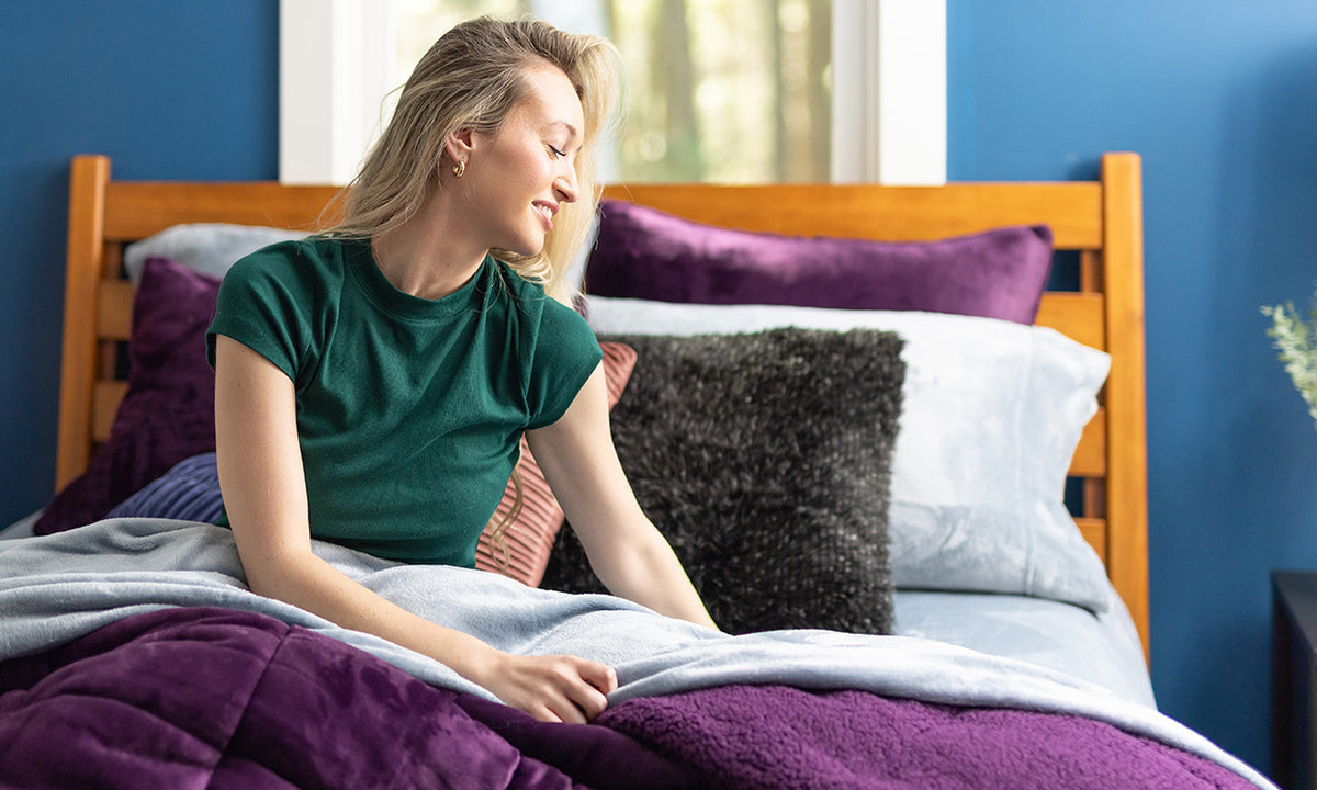 Female laying in bed using the Hidden Gem Blanket