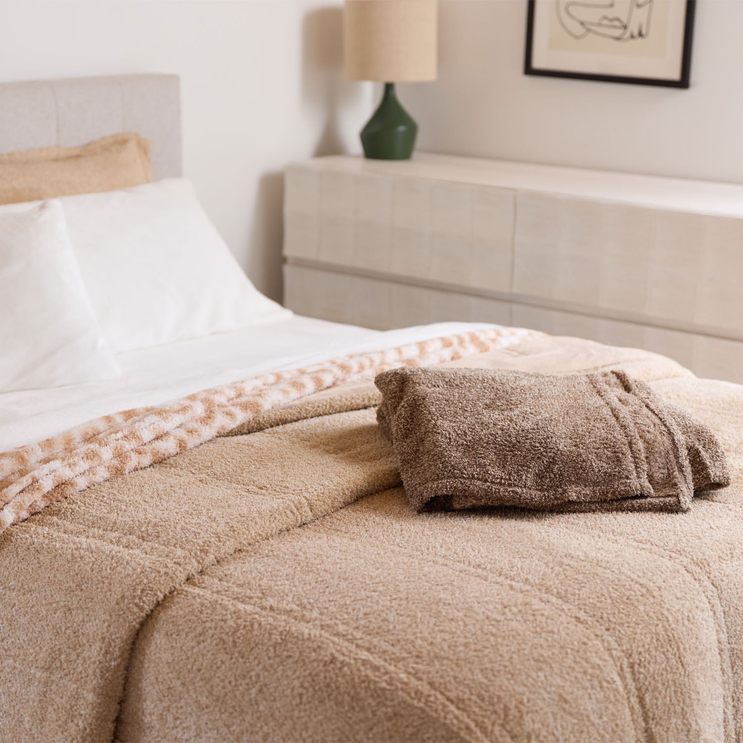 Beige blanket on a bed in a bedroom setting