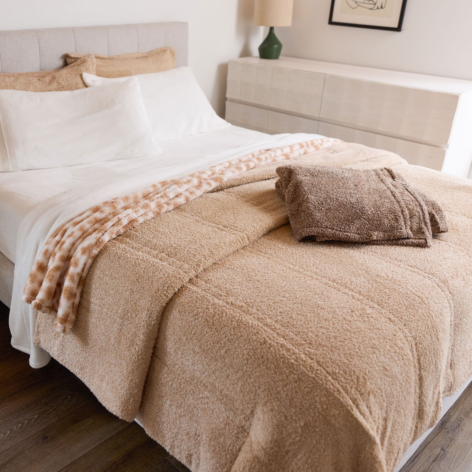 Beige blanket on a bed in a bedroom setting