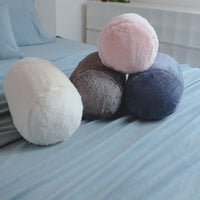 Video of 4 colorful Extra-Fluffy Neckroll Pillows on a bed.