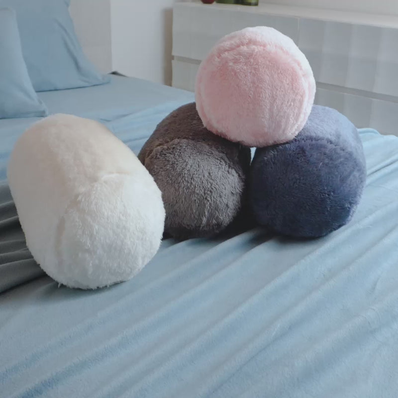 Video of 4 colorful Extra-Fluffy Neckroll Pillows on a bed.