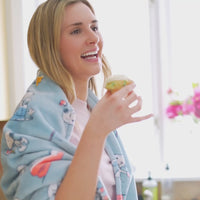 Peanuts VelvetLoft Throw listing video featuring a model eating a cupcake.